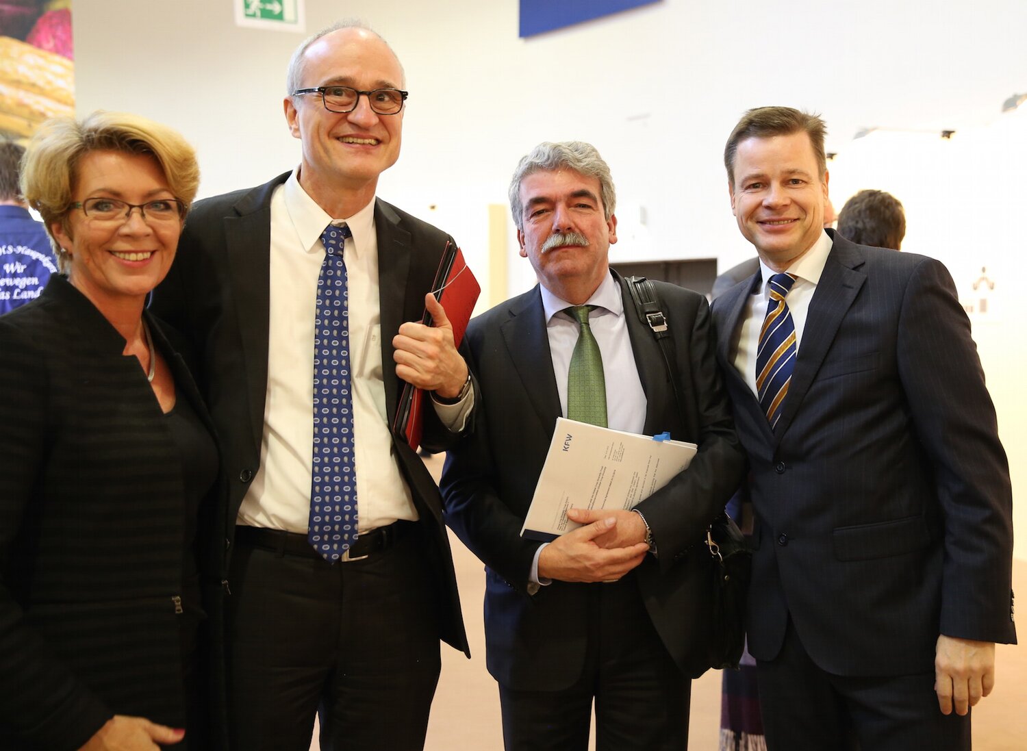 Marie Haga (far-left) and Michael Koch (far-right) show their appreciation to Deputy Director General at BMZ, Dr. Stefan Schmitz and Director at KfW, Dr. Christoph Kessler