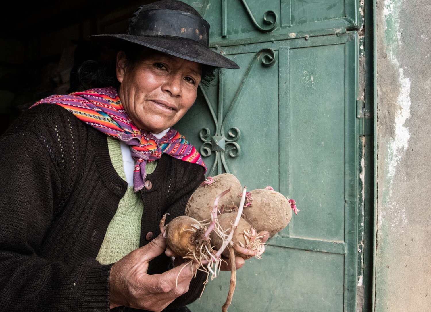 Woman holding potatoes.