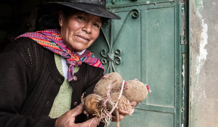 Woman holding potatoes.