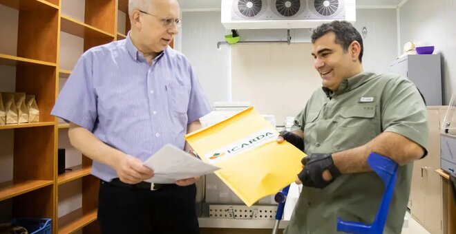 Dr. Hassan Machlab handing over the sealed seed packets to Michael Haddad in Terbol, Lebanon.