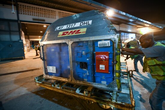 Staff at the courier company transfer the rice seeds to their depot at Abidjan International Airport, where they will be logged and stored overnight