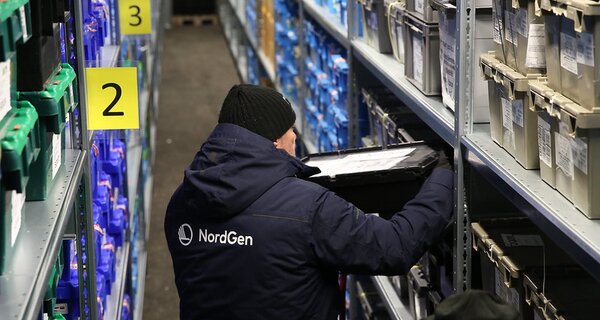 Person shelving container inside Svalbard Global Seed Vault