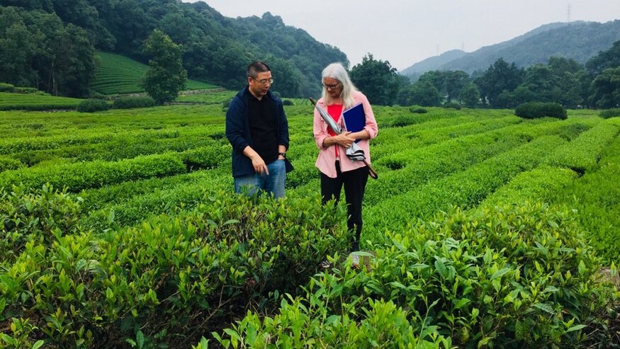 Two people standing in a field