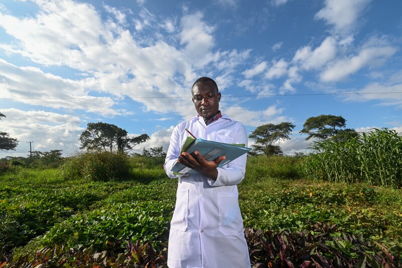Man taking notes in a field.