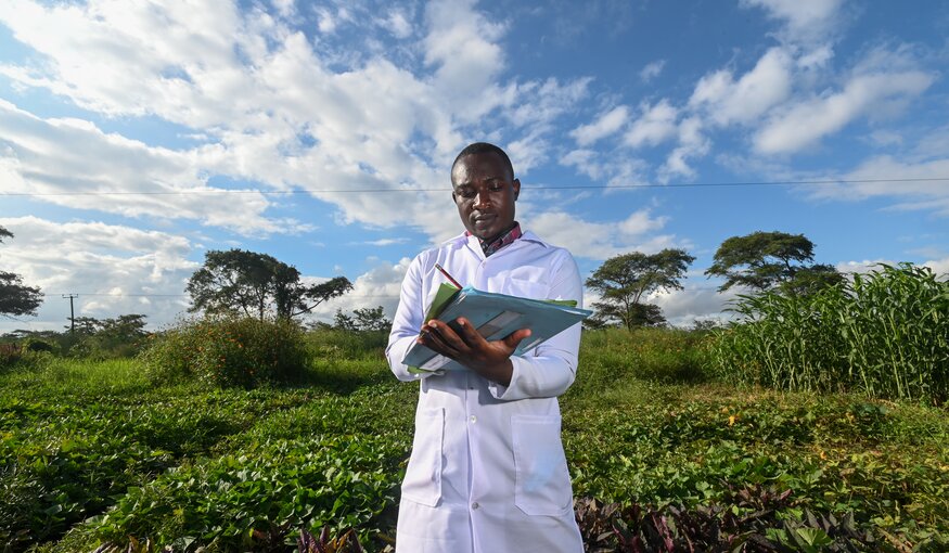 Man taking notes in a field.