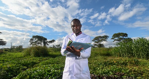 Man taking notes in a field.