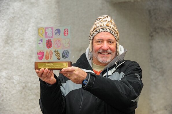 Dr. Ellis holding his Crop Trust Legacy Award. 