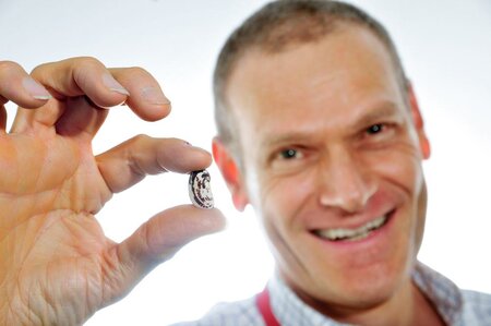 Dr. Debouck holding up a bean.