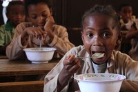 Under the school feeding program, children receive a nutritious collation three mornings a week, made of porridge produced locally and composed at 40% of beans flour. Credit: ©2014CIAT/StephanieMalyon