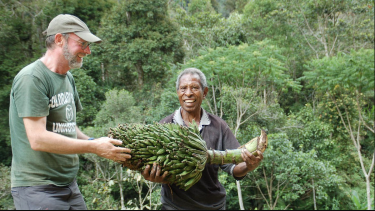 Panis and a Papua New Guinean guide hold their rare find of Musa ingens, a wild species that can grow up to 15 meters high. Photo: Sebastien Carpentier/The Alliance