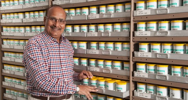 Dr. Upadhyaya standing in front of genebank seed collection.