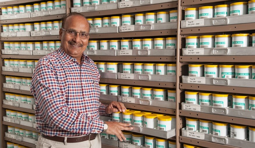 Dr. Upadhyaya standing in front of genebank seed collection.