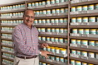 Dr. Upadhyaya standing in front of genebank seed collection. 