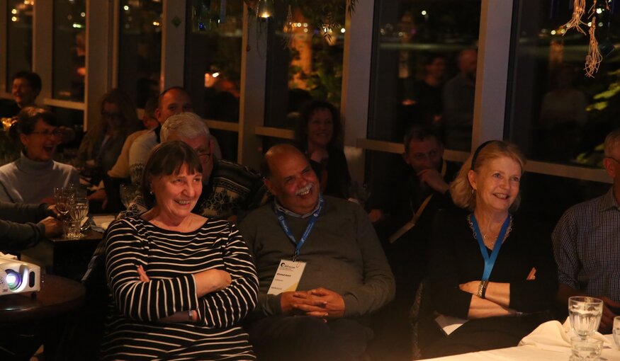 Guests watch the Legacy Award video honouring awardees.