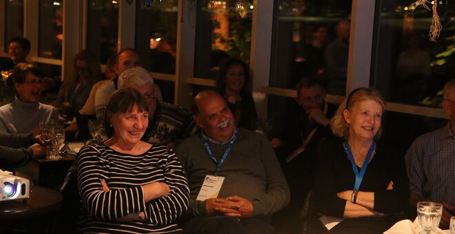 Guests watch the Legacy Award video honouring awardees.