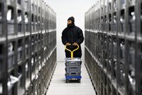A genebank worker wheels seeds through the AfricaRice genebank in Côte d’Ivoire, where the largest collection of African rice varieties in the world is safeguarded. Photo: Neil Palmer/Crop Trust