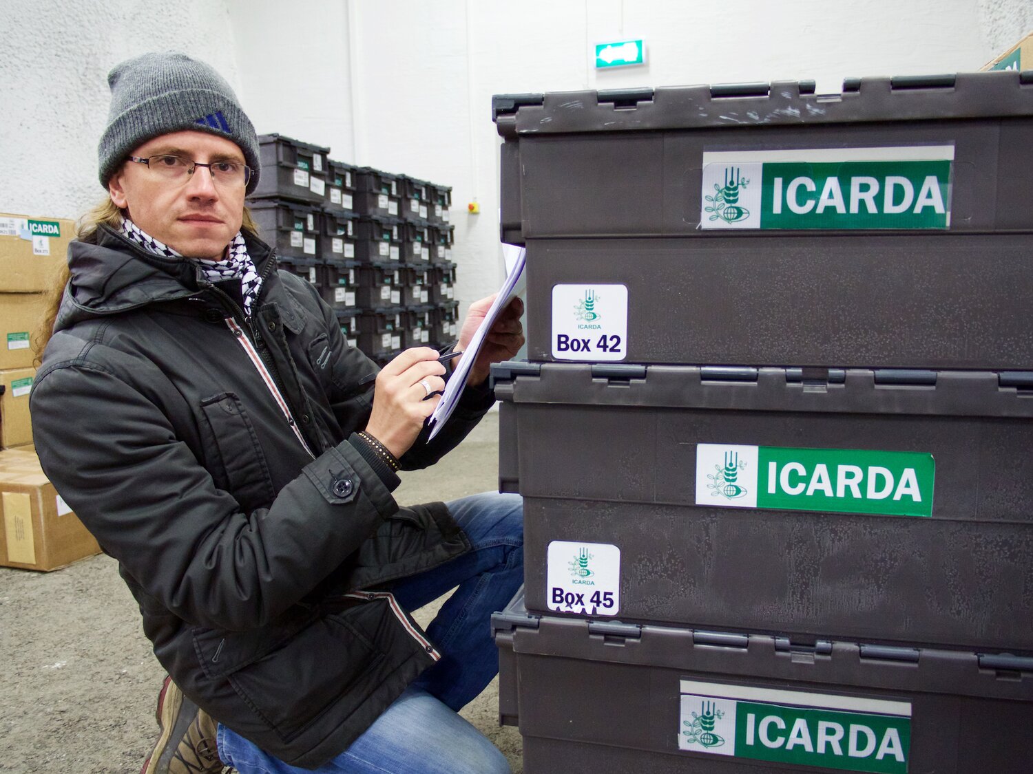 Athanasios Tsivelikas, ICARDA, checks seed boxes before removal from Global Seed Vault