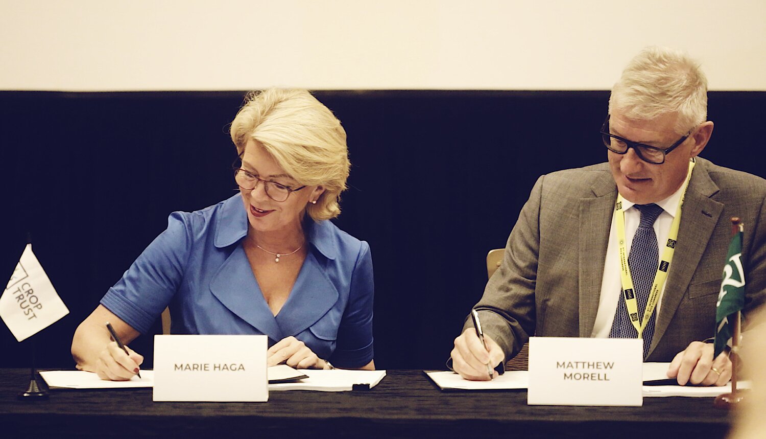 Crop Trust Executive Director, Marie Haga (right) and IRRI Director General, Matthew Morrel (left) signing the funding agreement in Singapore on World Food Day. 