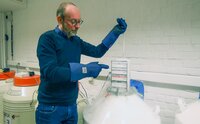Man displaying cryopreserved samples. 