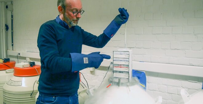 Man displaying cryopreserved samples.
