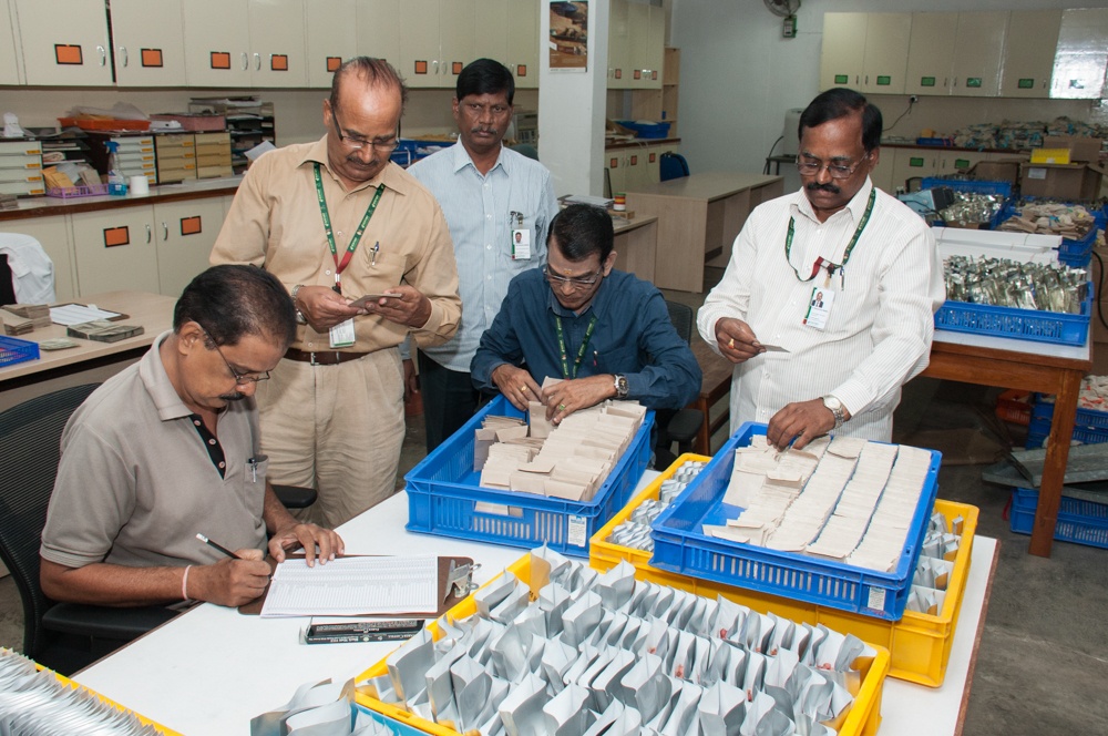 Dr. Upadhyaya with 4 other people preparing seed samples. 
