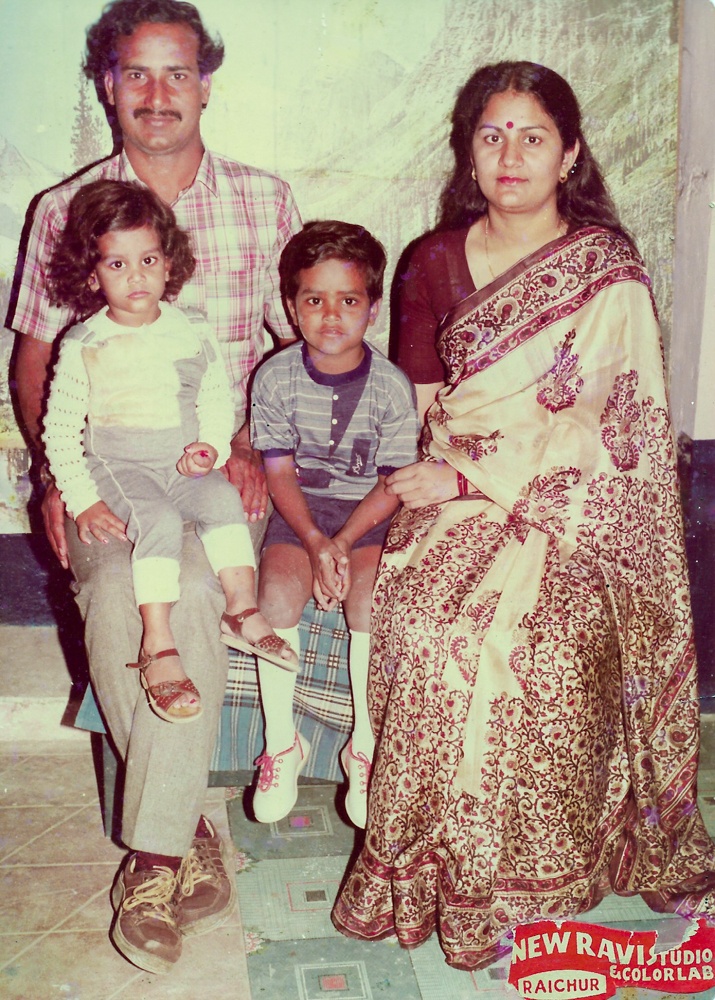 Family photo of Dr. Upadhyaya with wife and two children