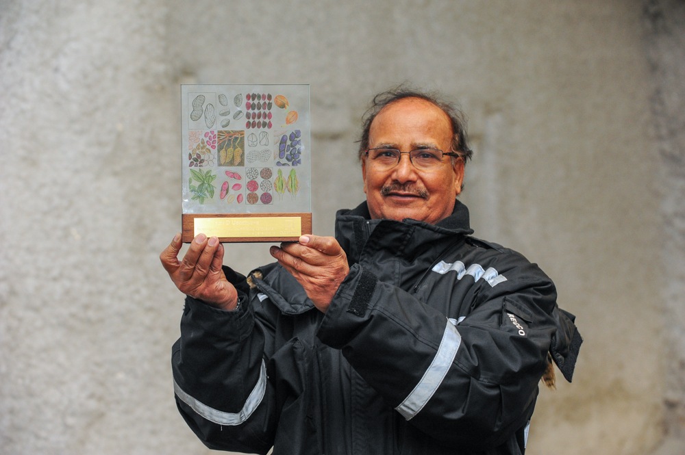 Dr. Upadhyaya holding his Crpo Trust Legacy Award. 