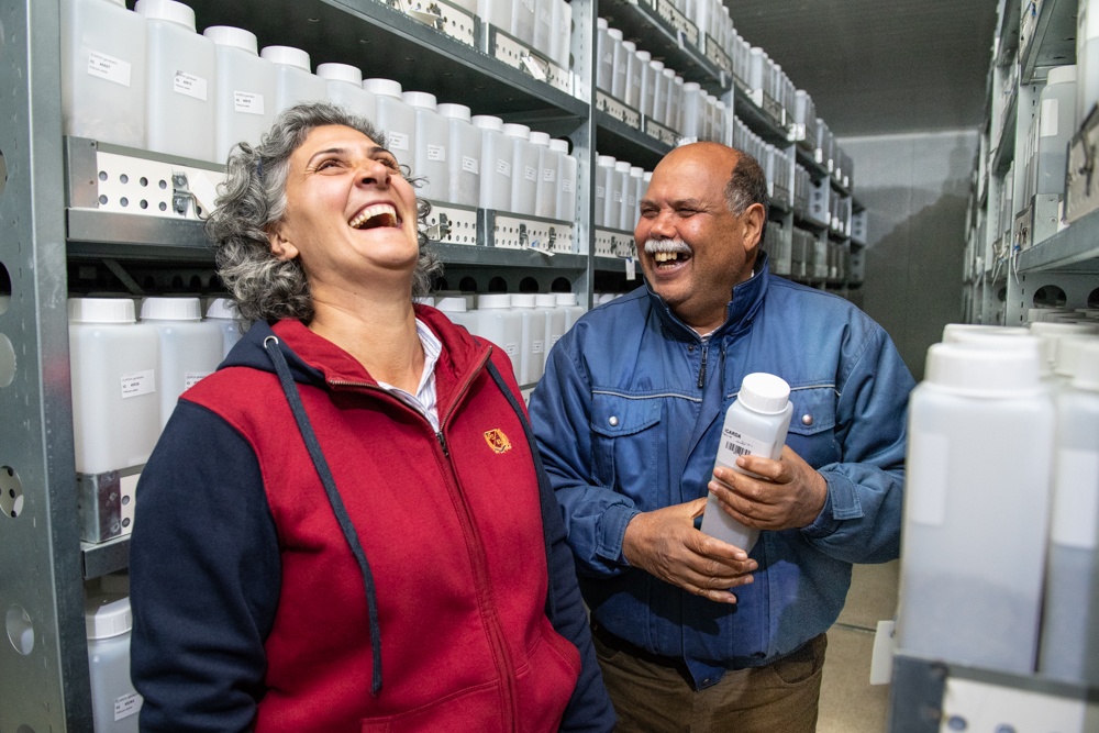 People laughing in a cold storage room.